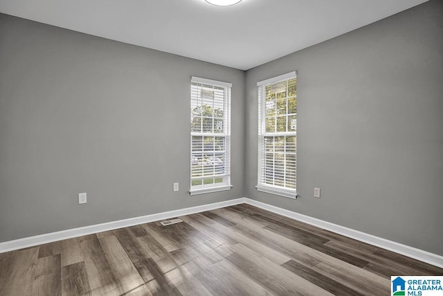 unfurnished room featuring hardwood / wood-style floors