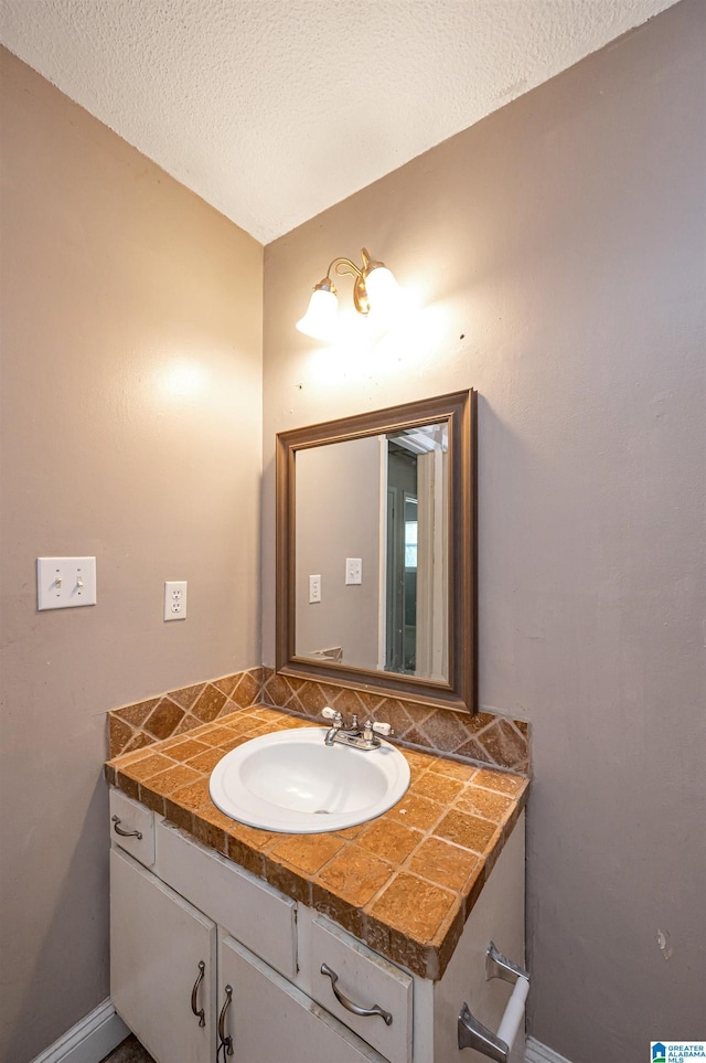 bathroom featuring vanity and a textured ceiling