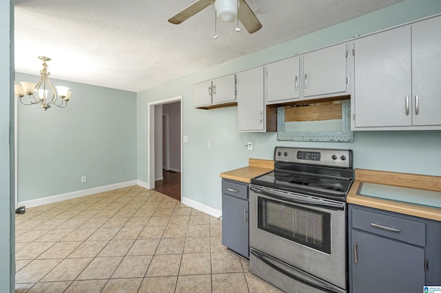 kitchen with wooden counters, decorative light fixtures, a textured ceiling, electric range, and gray cabinets