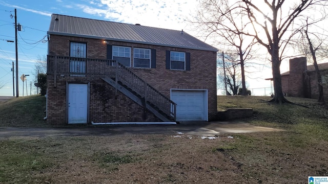 rear view of property featuring a garage