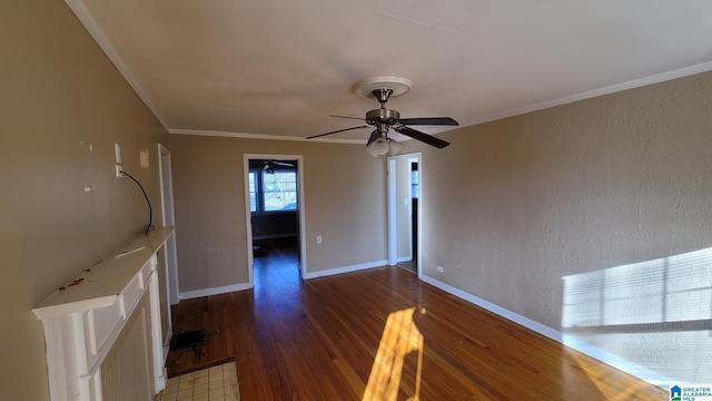 unfurnished living room featuring dark wood-type flooring, ornamental molding, and ceiling fan