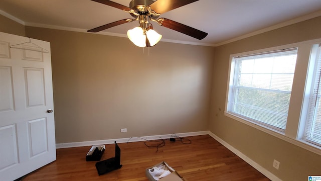 empty room featuring ornamental molding and wood-type flooring