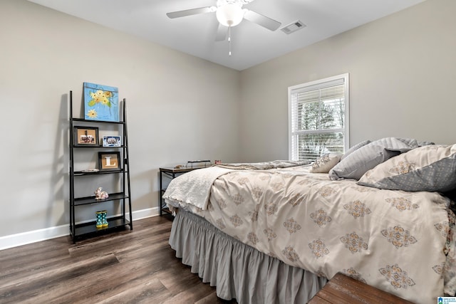 bedroom with dark hardwood / wood-style floors and ceiling fan