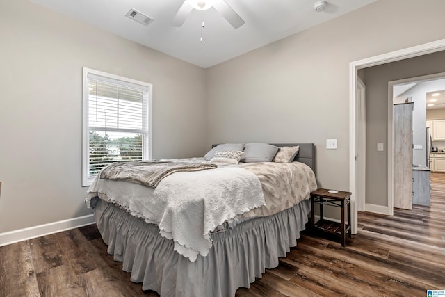 bedroom with ceiling fan and dark hardwood / wood-style flooring