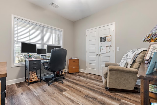 office area with hardwood / wood-style flooring and a healthy amount of sunlight