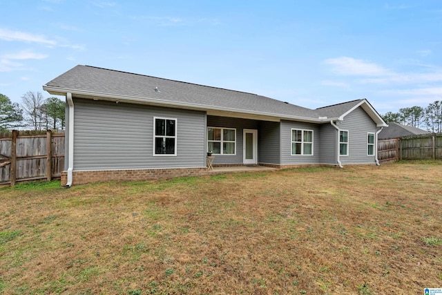 back of house with a lawn