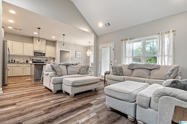 living room featuring hardwood / wood-style floors and vaulted ceiling