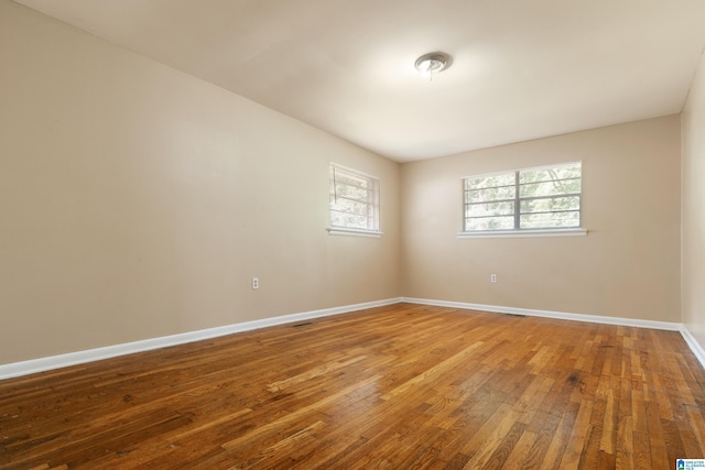 empty room with hardwood / wood-style floors