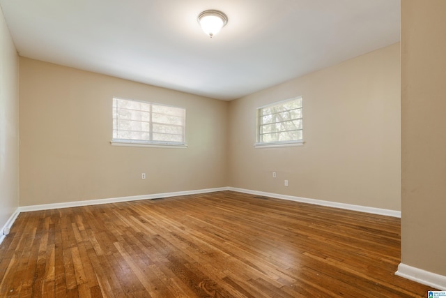 empty room with hardwood / wood-style floors