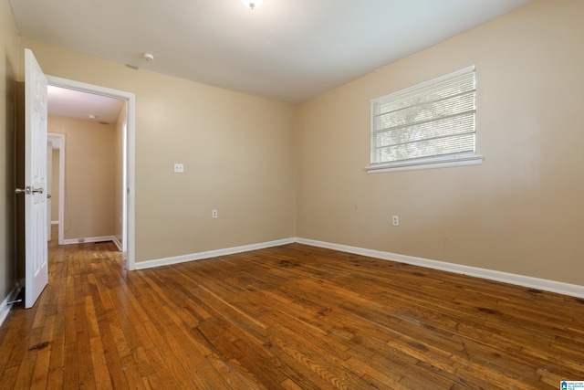 unfurnished room with dark hardwood / wood-style floors