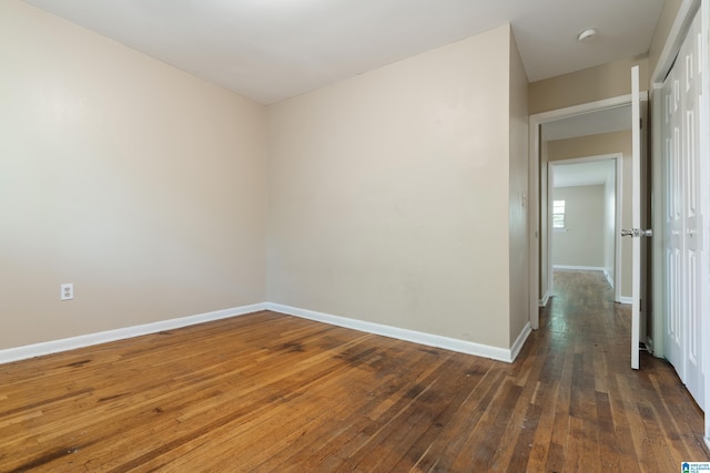 unfurnished room featuring dark hardwood / wood-style flooring