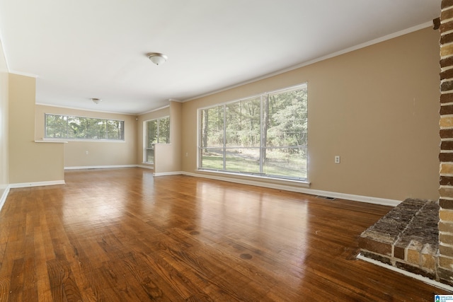 unfurnished living room featuring hardwood / wood-style flooring and ornamental molding