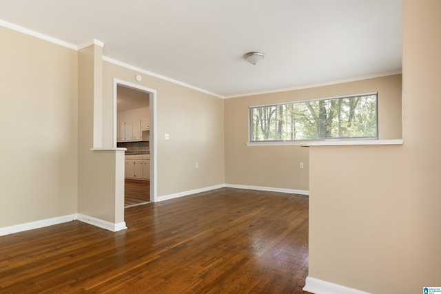 empty room featuring ornamental molding and dark wood-type flooring