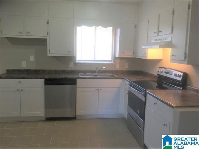 2838 Micmac Dr, Birmingham, AL 35215 - kitchen featuring a sink, extractor fan, appliances with stainless steel finishes, white cabinetry, and dark countertops