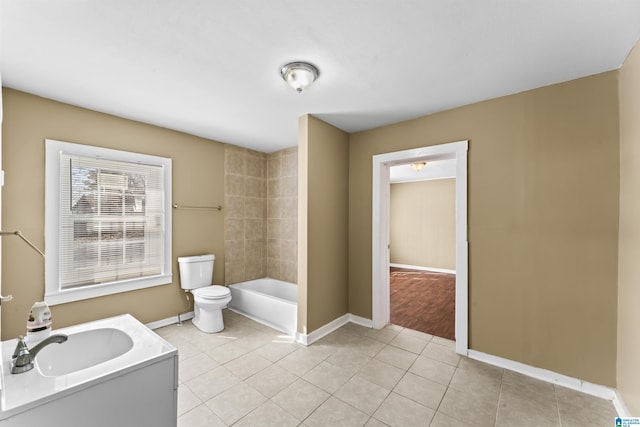 full bathroom with tiled shower / bath, tile patterned floors, toilet, and vanity