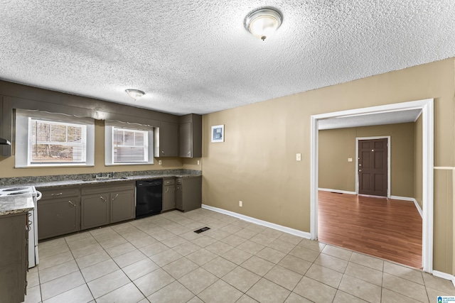 kitchen with light tile patterned floors, sink, dishwasher, white range with electric cooktop, and dark brown cabinetry