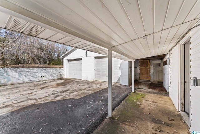 view of patio featuring an outbuilding and a garage