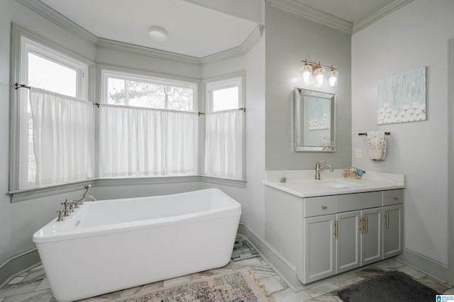 bathroom with ornamental molding, a washtub, and vanity