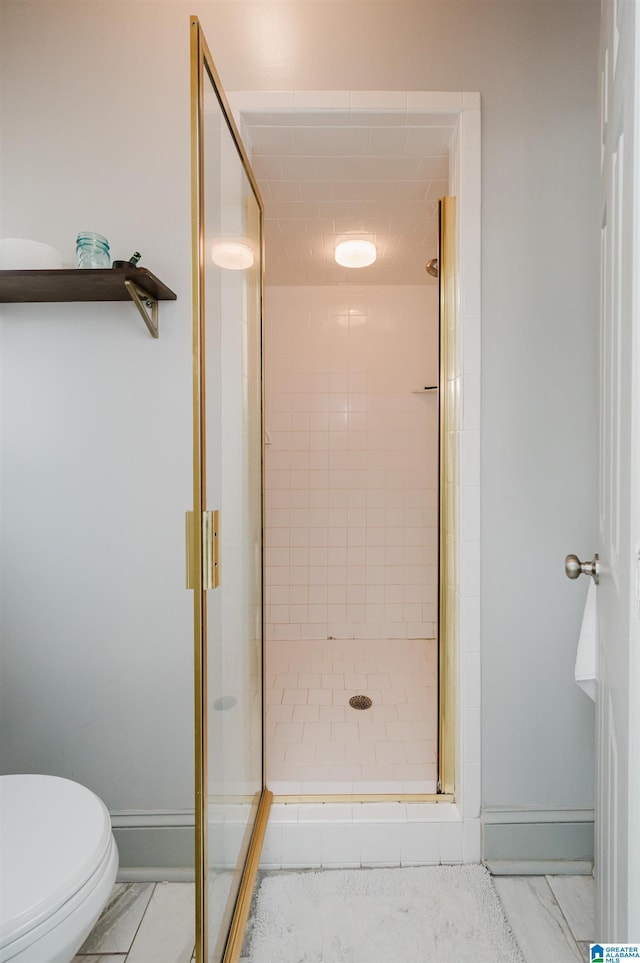 bathroom featuring walk in shower and toilet