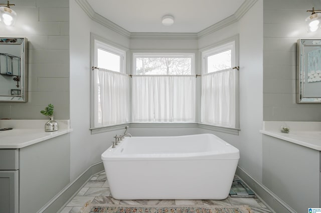 bathroom with vanity, a bathing tub, and crown molding