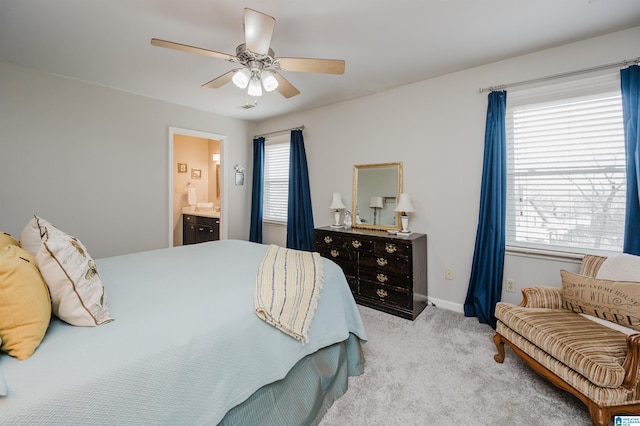 carpeted bedroom with ceiling fan and ensuite bath