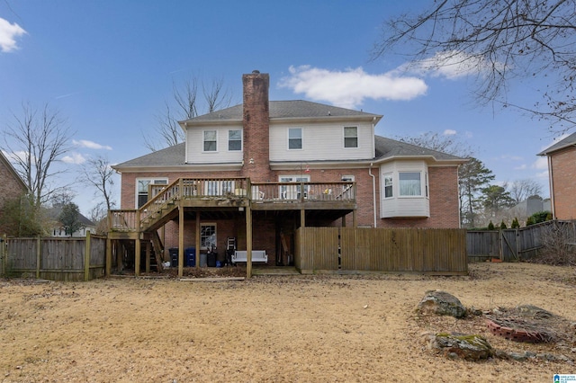 rear view of house featuring a wooden deck