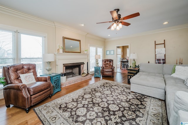 living room featuring hardwood / wood-style flooring, ornamental molding, and plenty of natural light