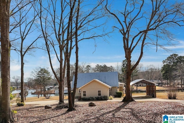 view of property exterior with a water view