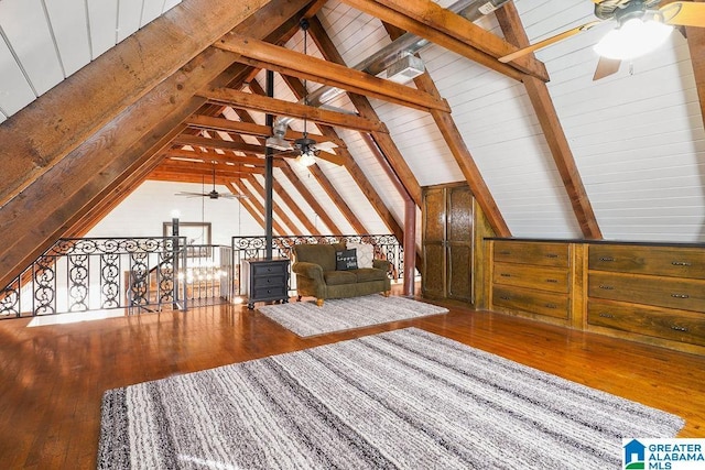 unfurnished living room with hardwood / wood-style floors and vaulted ceiling with beams