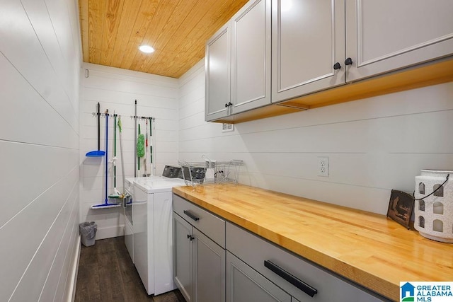 laundry room with cabinets, dark hardwood / wood-style floors, washer / clothes dryer, and wooden ceiling