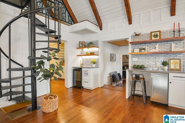 bar featuring beamed ceiling, white cabinetry, high end refrigerator, wine cooler, and dark wood-type flooring