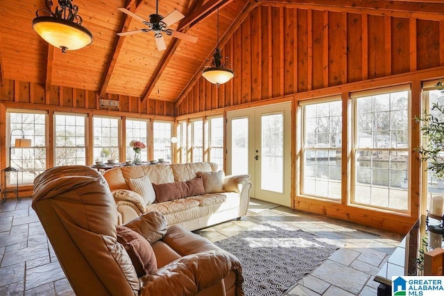 sunroom with lofted ceiling with beams, wooden ceiling, and ceiling fan