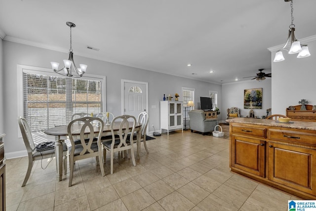 dining space featuring ornamental molding, visible vents, baseboards, and ceiling fan with notable chandelier