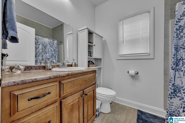 full bathroom featuring a shower with shower curtain, toilet, vanity, tile patterned flooring, and baseboards