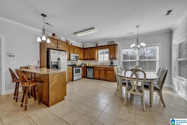 kitchen with stainless steel appliances, a peninsula, visible vents, brown cabinets, and an inviting chandelier