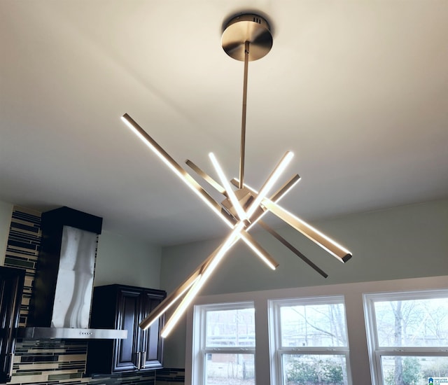 interior details featuring wall chimney exhaust hood