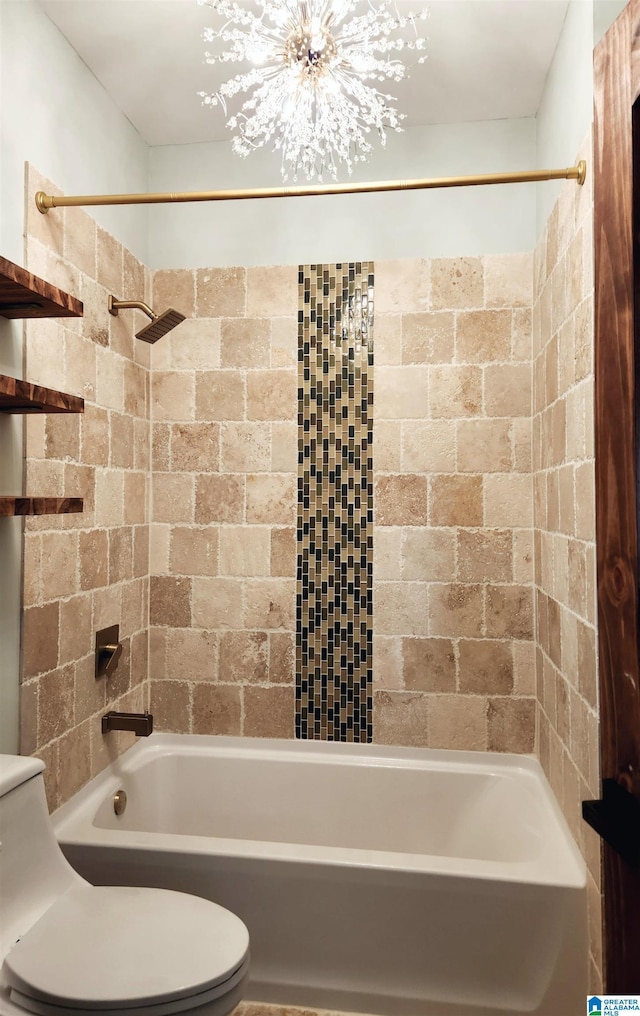 bathroom featuring tiled shower / bath and toilet