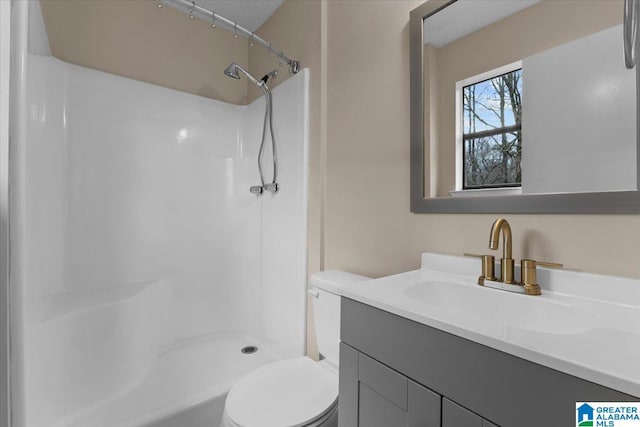 bathroom with vanity, curtained shower, and toilet