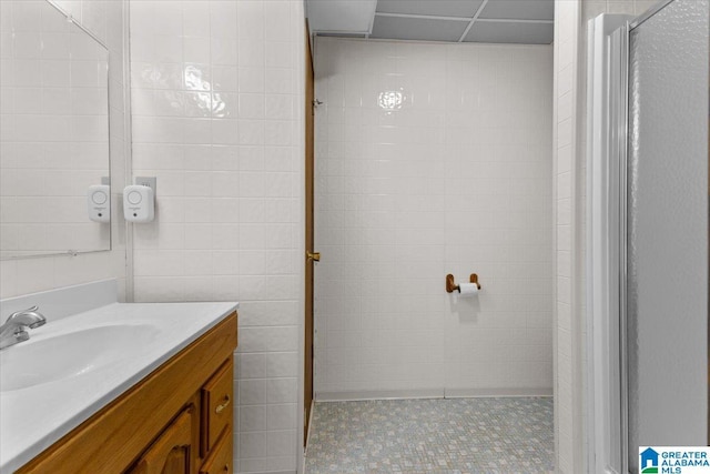 bathroom featuring vanity and a shower with door