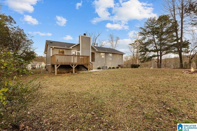 back of property featuring a lawn, central air condition unit, and a deck