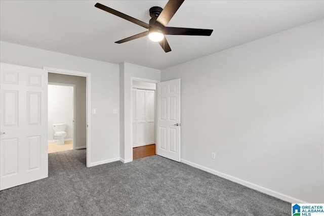 unfurnished bedroom featuring ceiling fan, a closet, and dark colored carpet