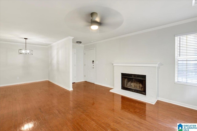 unfurnished living room featuring crown molding, wood-type flooring, and ceiling fan