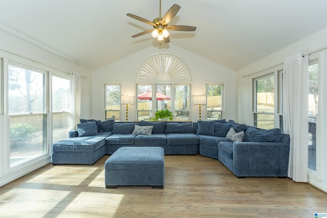 sunroom with ceiling fan and vaulted ceiling