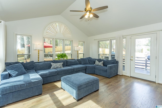 living room featuring ceiling fan, plenty of natural light, high vaulted ceiling, and light wood-type flooring