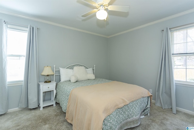 bedroom with multiple windows, crown molding, light colored carpet, and ceiling fan