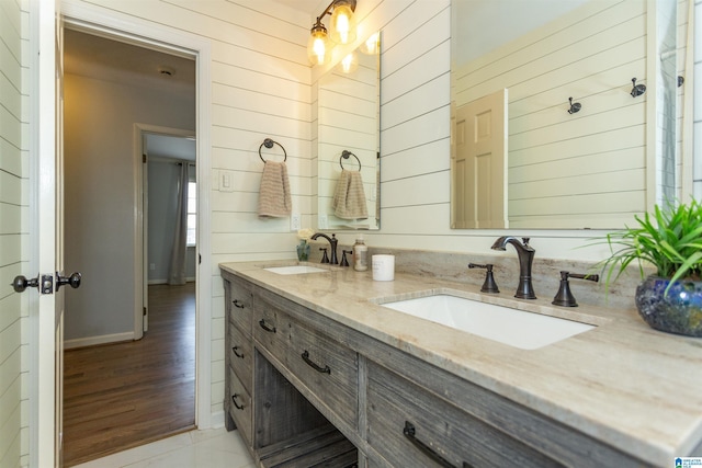 bathroom with vanity and wood walls