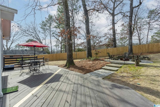 wooden deck featuring an outdoor fire pit