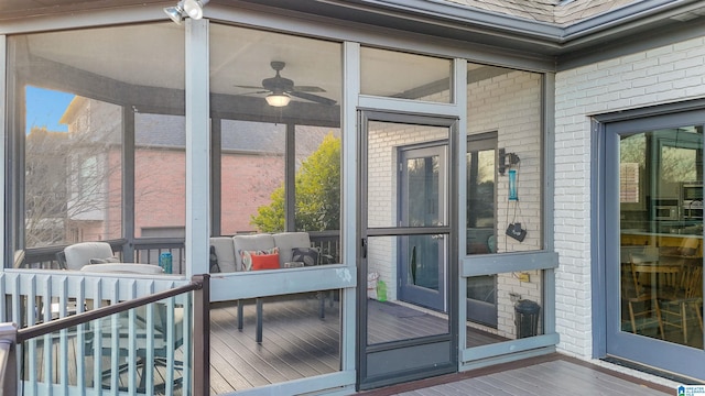 sunroom / solarium featuring ceiling fan