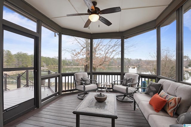 sunroom featuring a water view, ceiling fan, and a wealth of natural light