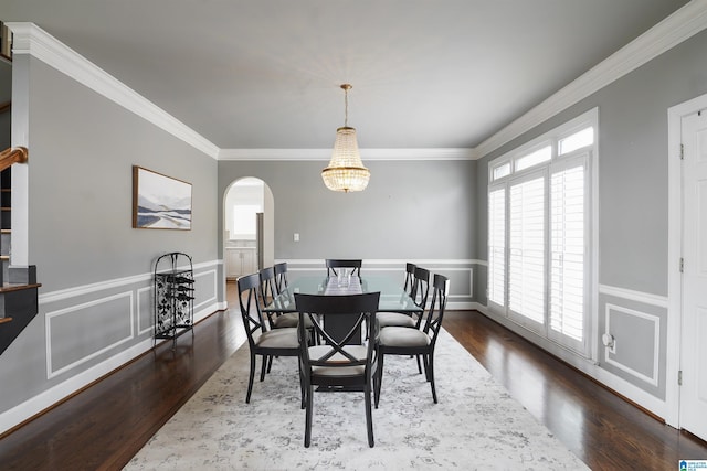 dining space with dark wood-type flooring and ornamental molding